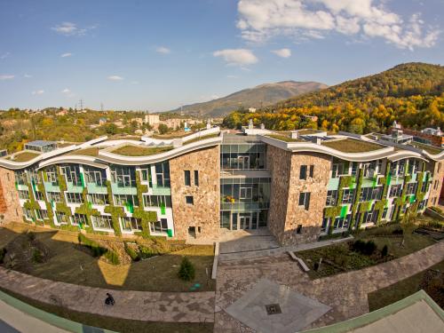 Curved green roof and green facades on a large building